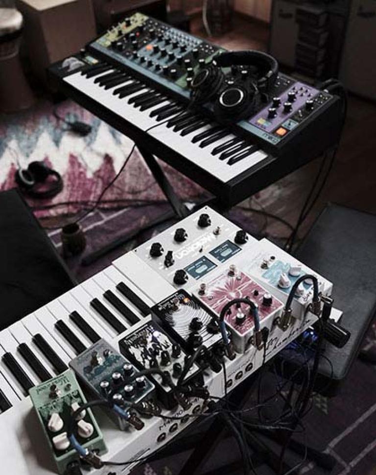 A picture of two synthesizers with various effect pedals