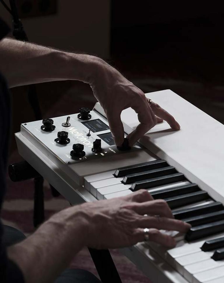 A musician playing a synthesizer